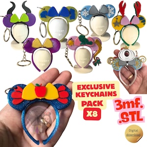 May include: A collection of eight 3D-printed character-themed ear keychains featuring various colours and designs, including a blue glittery keychain with a red apple, a carriage, and other motifs, accompanied by text reading EXCLUSIVE KEYCHAINS PACK X8 3mf. STL.