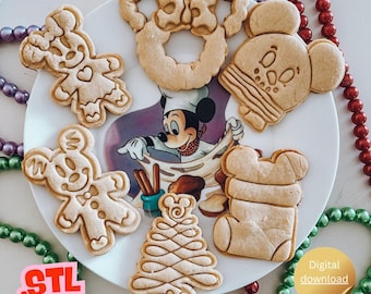 May include: A plate with various gingerbread cookies in the shape of Mickey Mouse, Minnie Mouse, a Christmas tree, and a stocking. The plate has a Mickey Mouse graphic. The words "Digital download" are in a gold circle. The word "STL" is in the lower left corner.