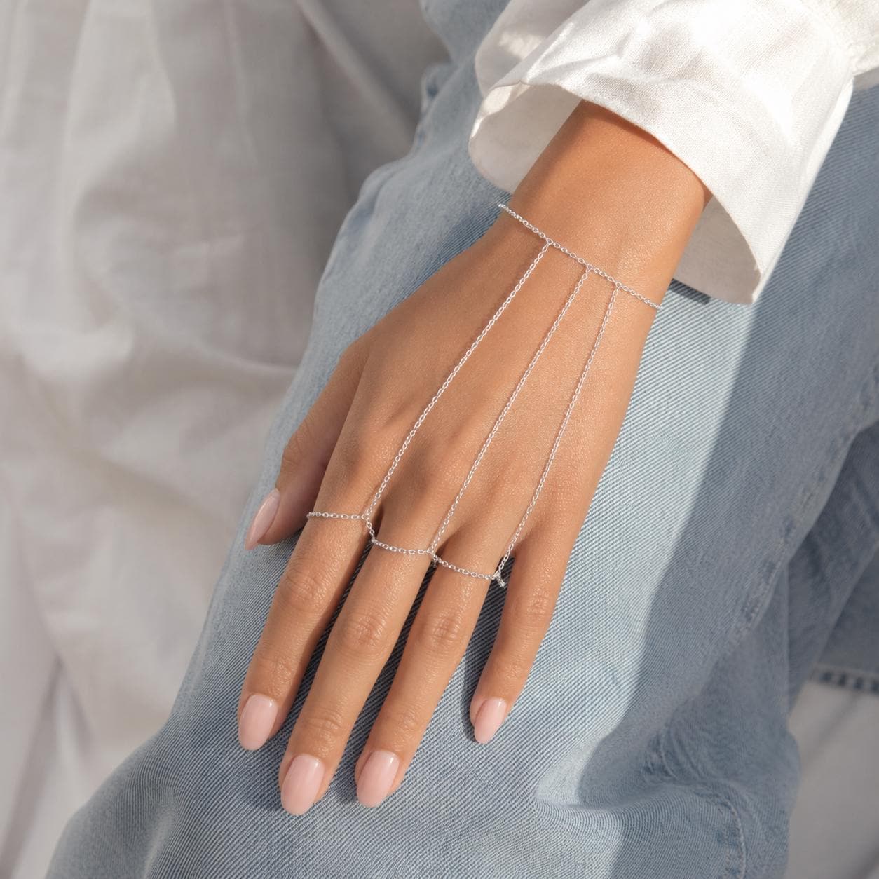 Delicate gold stainless steel hand chain draping wrist to fingers, bohemian slave bracelet style hand jewelry