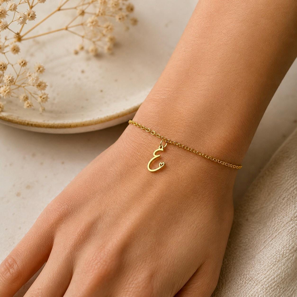 Gold stainless steel personalized initial bracelet with dainty cursive charm, handcrafted minimalist design
