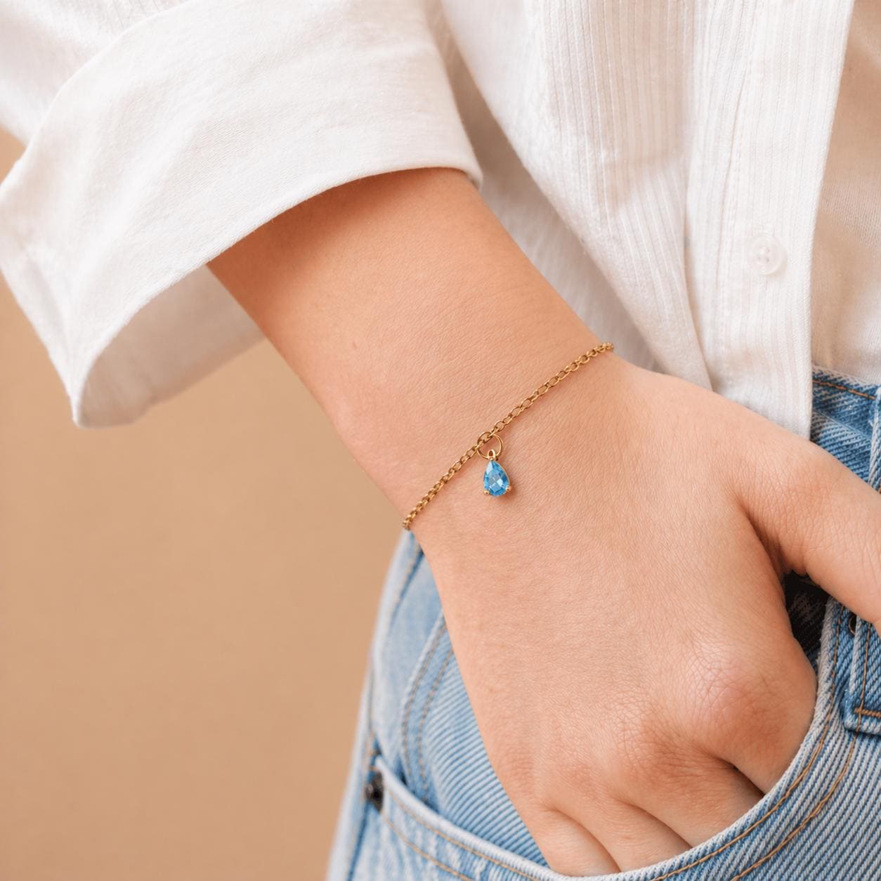 Dainty gold stainless steel birthstone bracelet with personalized gemstone charm for everyday wear