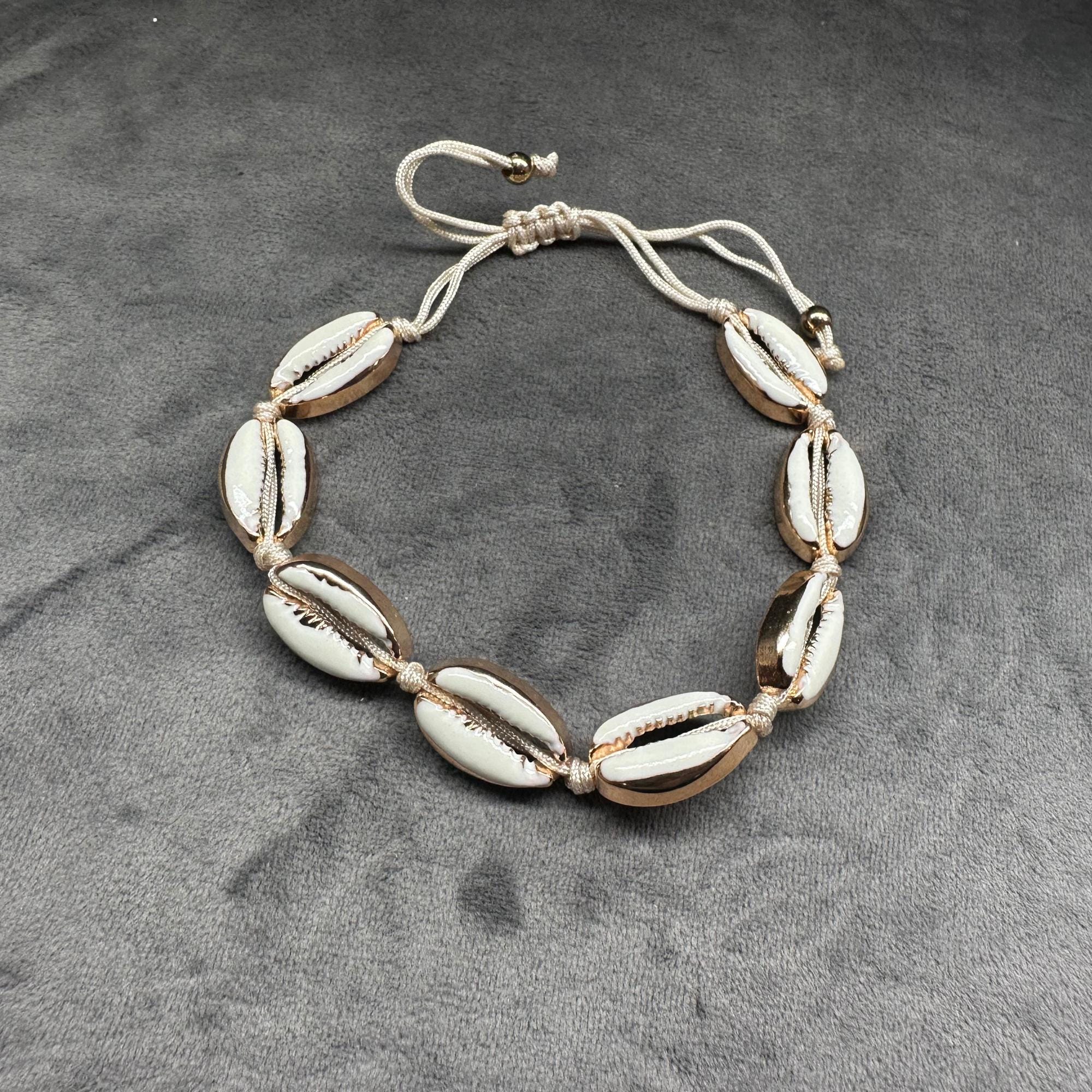 Gold-tone cowrie shell anklet with natural boho beach design, adjustable ankle bracelet for barefoot summer style
