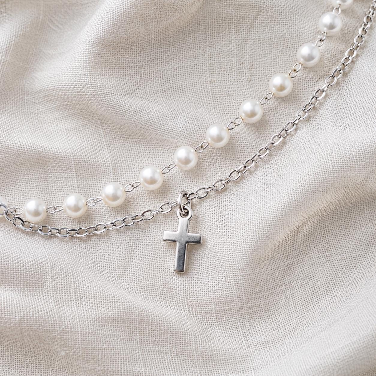Delicate gold stainless steel pearl bracelet with cross charm for meaningful occasions
