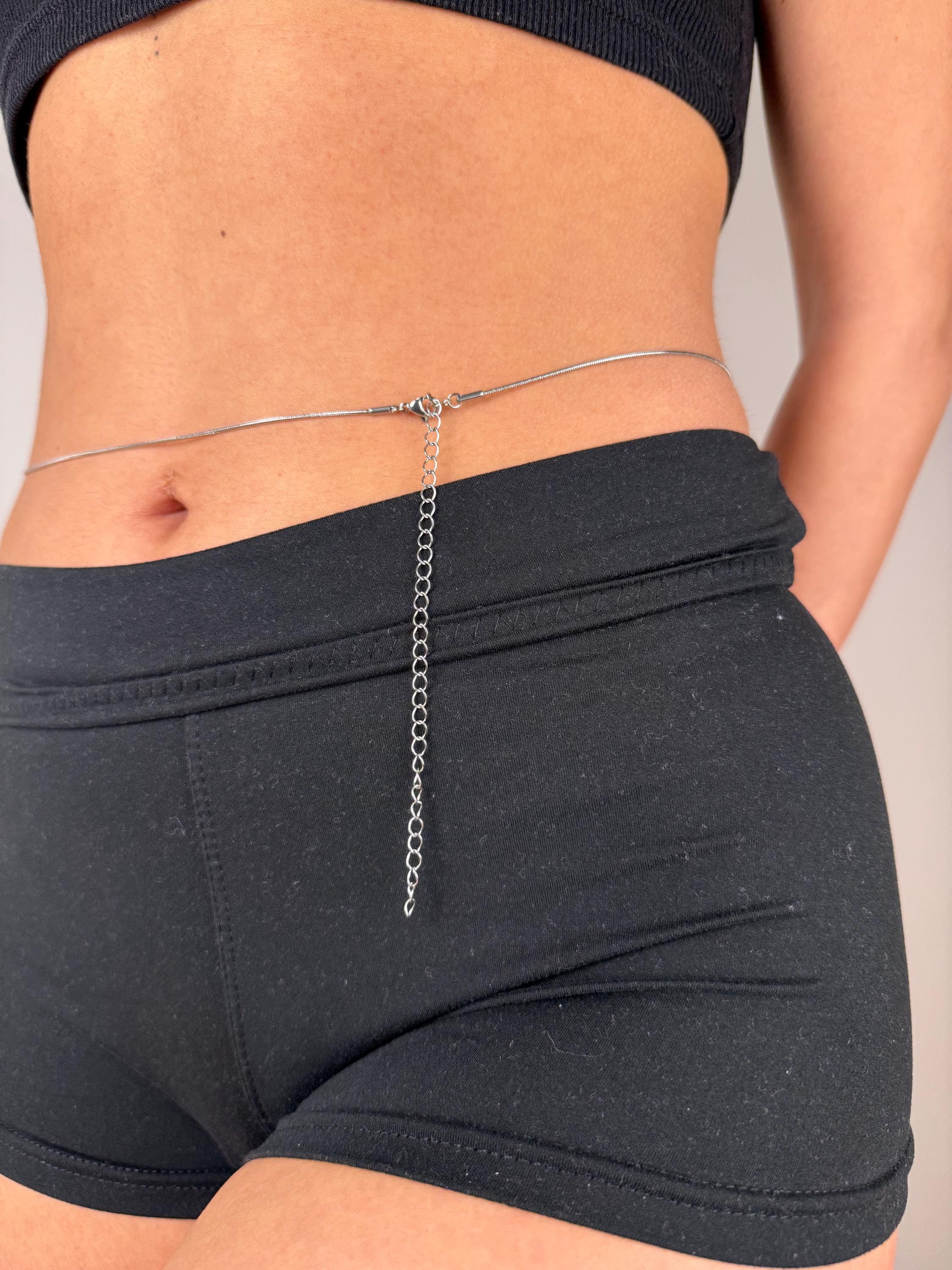 Gold tone stainless steel snake belly chain draped on waist, minimalist summer jewelry accessory