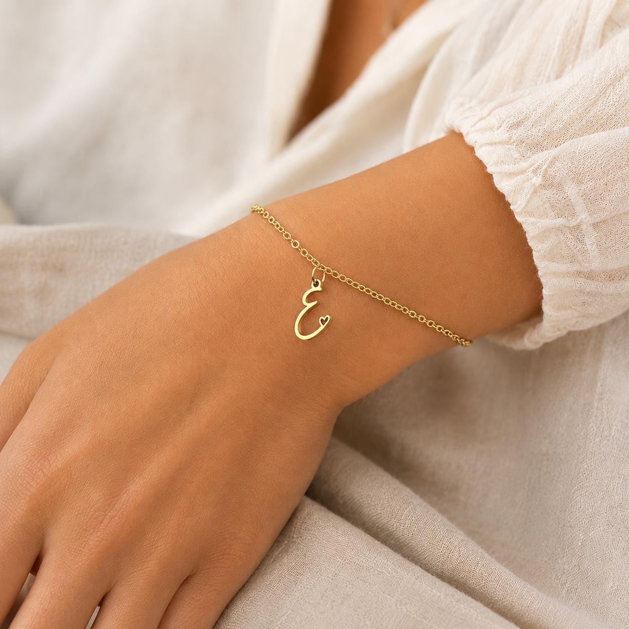 Gold stainless steel personalized initial bracelet with dainty cursive charm, handcrafted minimalist design