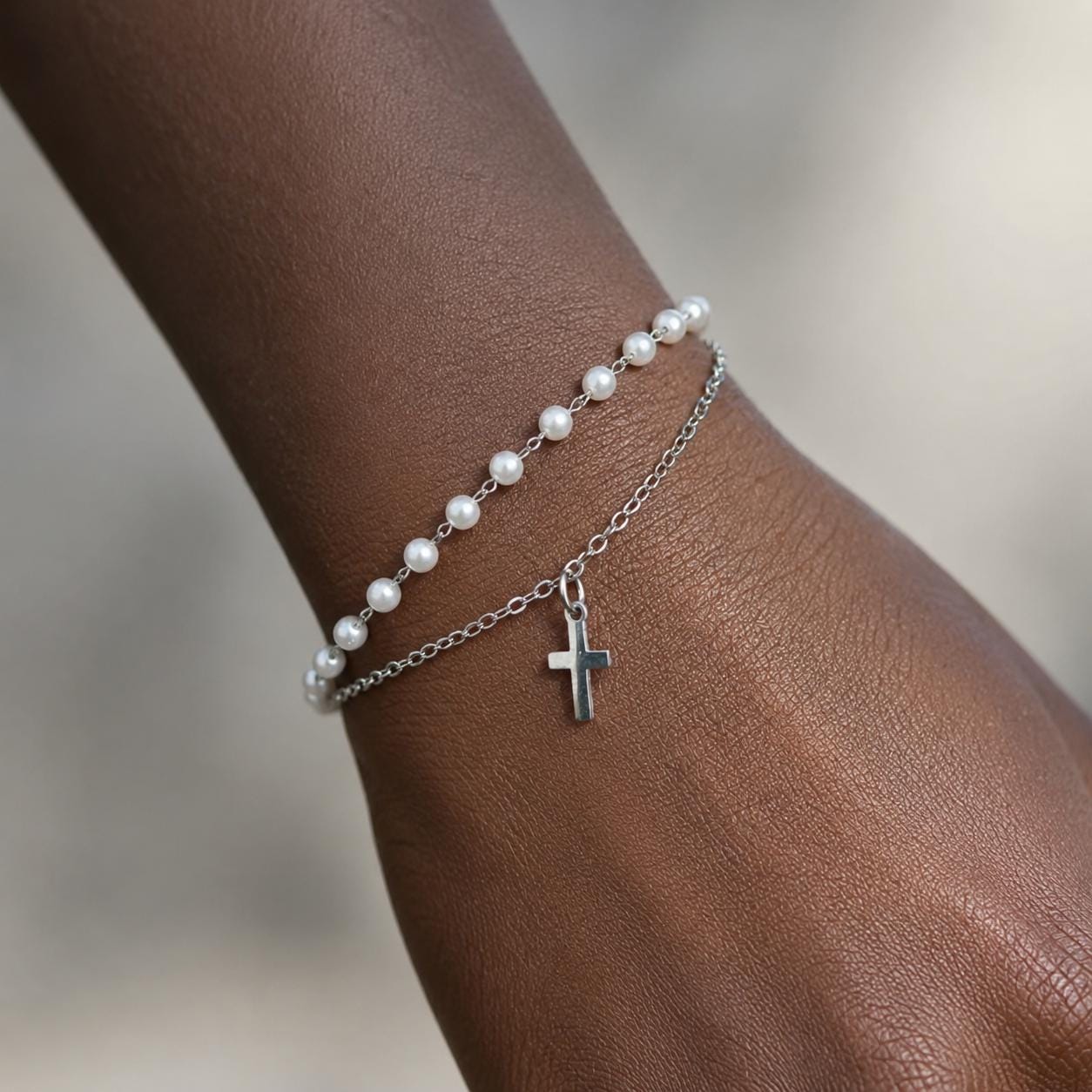 Delicate gold stainless steel pearl bracelet with cross charm for meaningful occasions