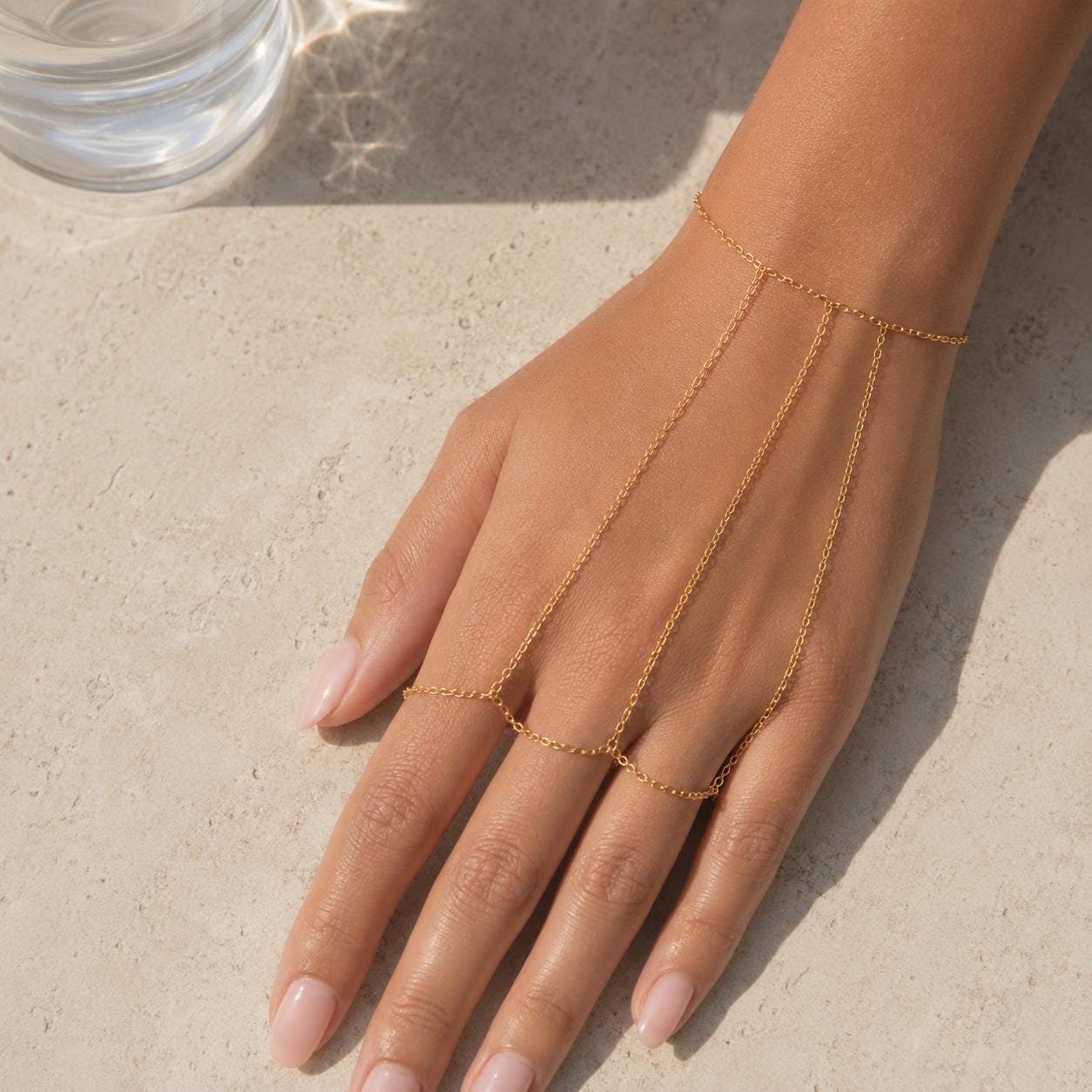 Delicate gold stainless steel hand chain draping wrist to fingers, bohemian slave bracelet style hand jewelry