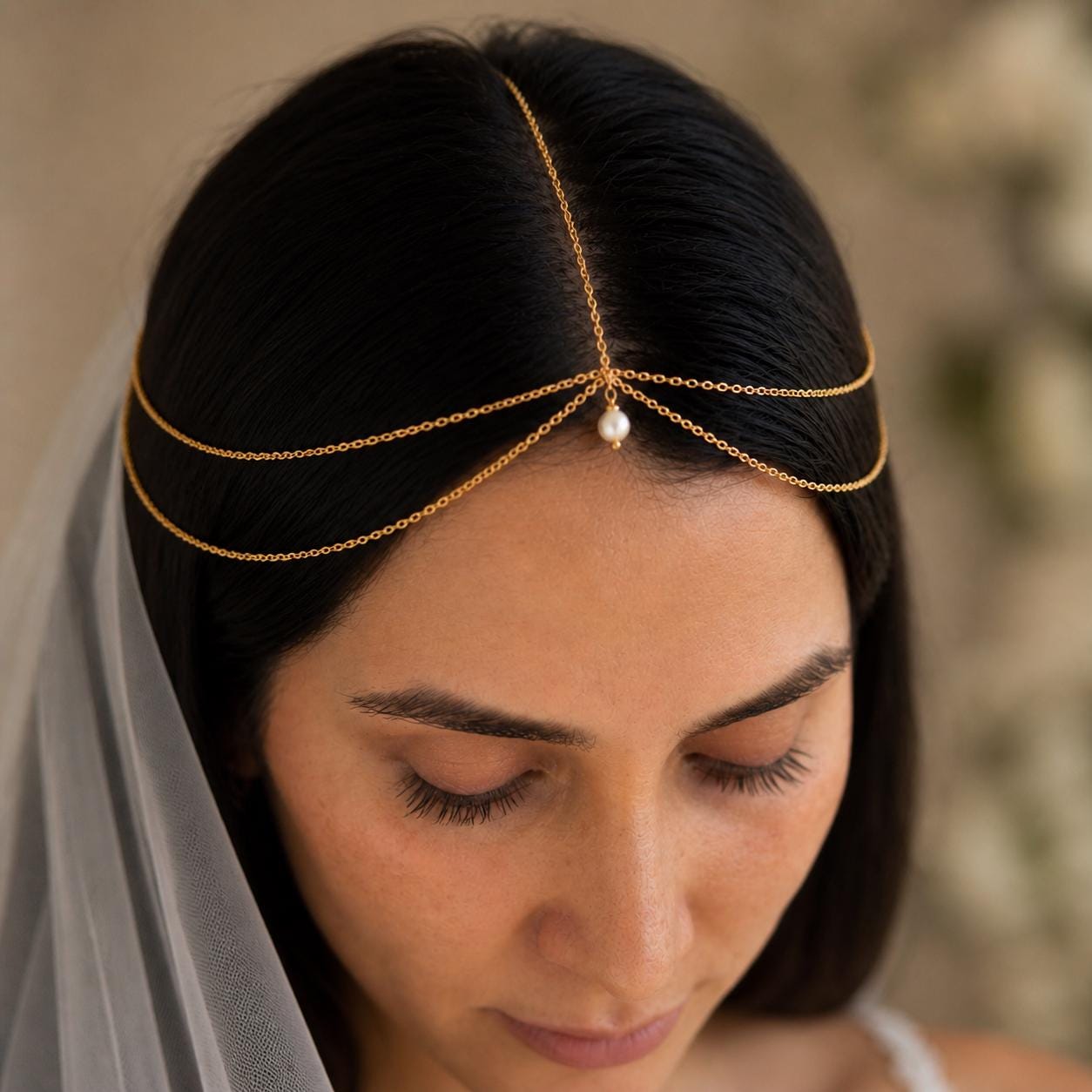 Delicate pearl bridal head chain in gold-tone stainless steel for wedding hairstyles and special occasions