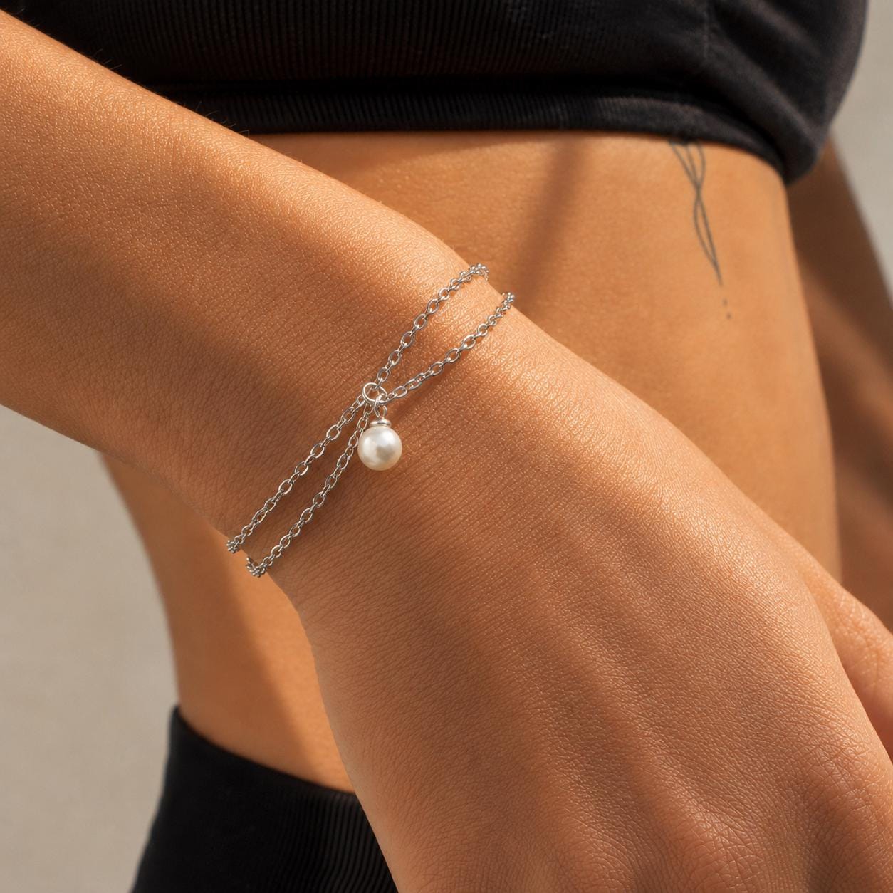 Delicate gold stainless steel pearl charm bracelet with dual strands for everyday wear