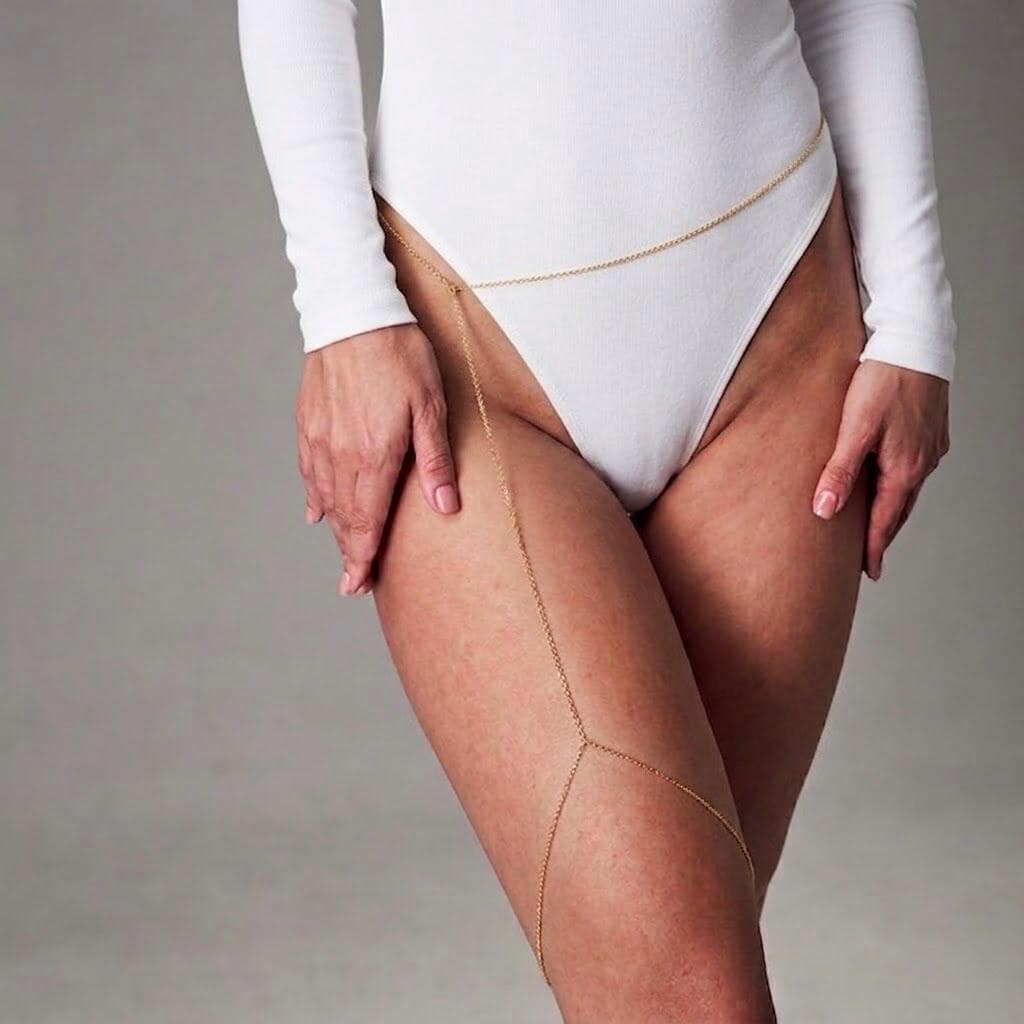 Delicate gold tone stainless steel thigh chain body jewelry for festival wear and editorial styling