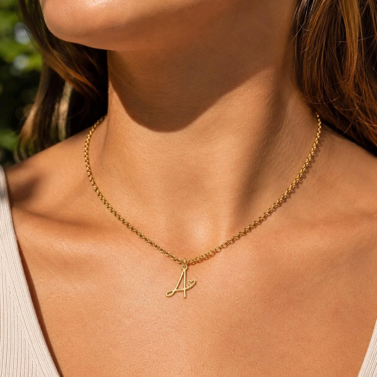 Delicate gold monogram letter necklace in stainless steel, personalised initial charm for everyday wear