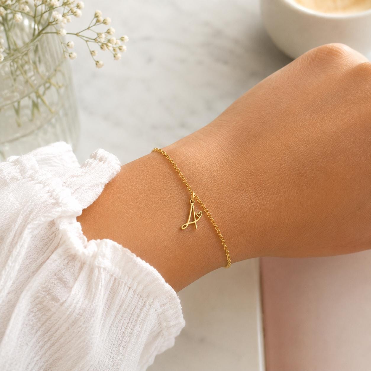 Gold stainless steel personalized initial bracelet with dainty cursive charm, handcrafted minimalist design