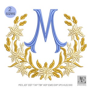 May include: An embroidery design featuring a large light blue letter M centred within a circular wreath of cream-coloured lilies and golden-yellow leaves. A small blue circle in the top left corner reads 2 sizes. File formats are listed at the bottom.