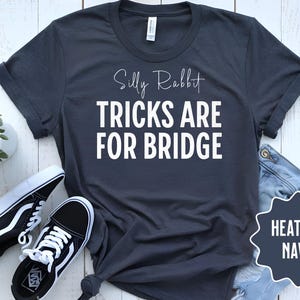 May include: Heather navy blue t-shirt with the text "Silly Rabbit Tricks Are For Bridge".
