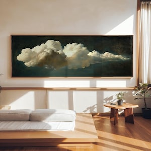 Peut inclure: Une œuvre d'art rectangulaire encadrée représentant un grand nuage cotonneux sur fond sombre. Le nuage est rendu dans des tons de blanc, crème et brun, avec des reflets subtils. Le cadre est en bois naturel et l'œuvre est exposée dans une pièce lumineuse.