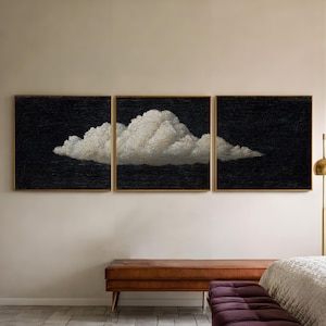 May include: A set of three framed artworks depicting a textured white cloud against a black backdrop. The cloud is the focal point of the central panel, with its edges extending into the adjacent panels. The frames have a gold finish.