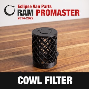 May include: A black cylindrical cowl filter with a lattice grid pattern, featuring the text Eclipse Van Parts embossed on the base and a circular logo on the top. The image includes the text Eclipse Van Parts RAM PROMASTER 2014-2022 and COWL FILTER.