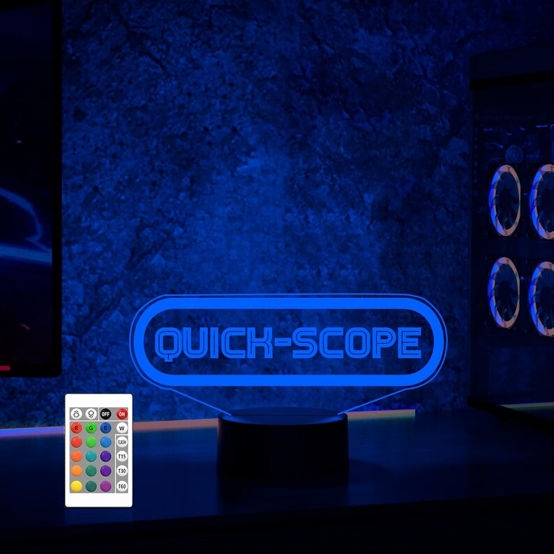 May include: A blue neon sign with the text "QUICK-SCOPE" on a black base. The sign is illuminated and has a remote control with multiple color options.