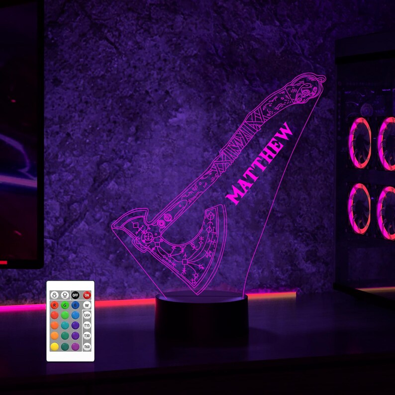 May include: A purple LED night light shaped like an axe with intricate designs. The axe has the name "MATTHEW" written on it. The light is controlled by a remote with multiple color options.