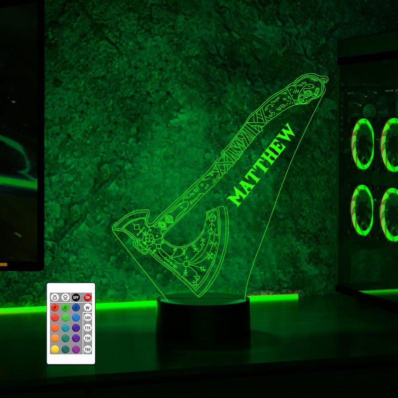 May include: A green LED night light shaped like an axe with intricate designs. The name "MATTHEW" is written on the handle. The light is on a black base and has a remote control.