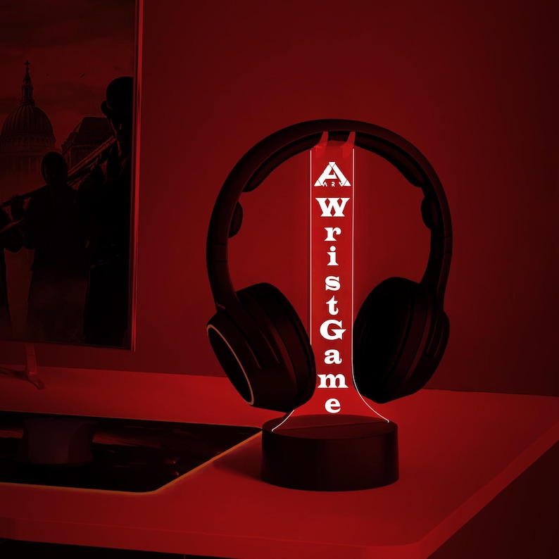 May include: A black and red LED night light shaped like a headphone stand with the word "Wrist Game" written vertically on the front.