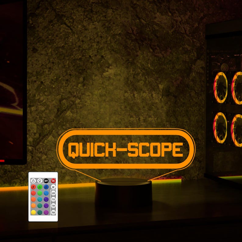May include: A 3D printed orange neon sign with the text "QUICK-SCOPE" on a black base. The sign is illuminated and has a remote control with multiple color options.