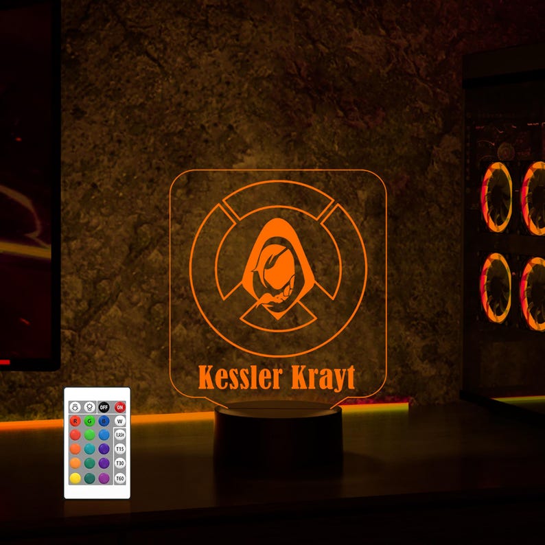 May include: Orange LED night light with a hooded figure design and the name "Kessler Krayt" printed below. The light is on a black base and has a remote control with multiple color options.