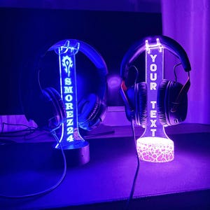 May include: Two illuminated headphone stands with custom text. The stand on the left has the text "SMOREZZ24" and the stand on the right has the text "YOUR TEXT".