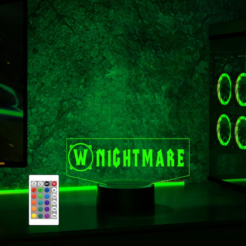May include: A green LED light with a black base and a remote control. The light features the text "W NIGHTMARE" in a white font.