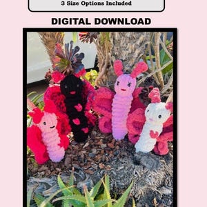 May include: Three crocheted butterfly toys in pink, white, and black. The butterflies are sitting on a bed of brown mulch and green plants. The image includes the text "Bailey the Butterfly", "PDF Pattern + Pictures", "3 Size Options Included", and "Digital Download".
