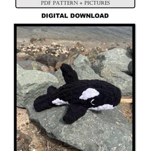 May include: A black and white crocheted orca whale toy resting on a gray rock. The toy has white patches and a small eye. Text at the top reads "OTTO THE ORCA WHALE" and "PDF PATTERN + PICTURES". Below that, the text reads "DIGITAL DOWNLOAD".