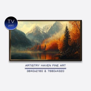 Puede incluir: Pintura de paisaje enmarcada que representa una escena de montaña con un lago que refleja los colores del otoño. La obra presenta montañas nevadas, bosques exuberantes y un lago tranquilo. El texto "TV ART" está en la esquina superior izquierda. El texto "ARTISTRY HAVEN FINE ART" está en la parte inferior.