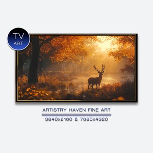 Puede incluir: Impresión artística enmarcada de un paisaje con un ciervo en un bosque. La obra presenta un río sereno, follaje otoñal dorado y una luz cálida. El texto "TV ART" está en la esquina superior izquierda.