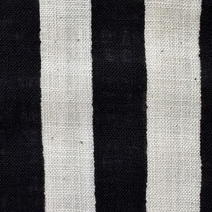 May include: A textile fabric featuring a repeating pattern of vertical stripes in solid black and off-white. The material displays a visible woven texture with a consistent weave density throughout, creating a high-contrast linear design.