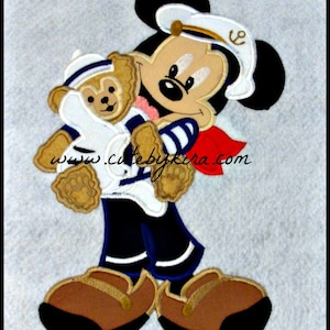 May include: A cartoon Mickey Mouse wearing a sailor hat and holding a brown teddy bear. Mickey is wearing a blue and white striped shirt with a red scarf. The text "www.cutebykira.com" is on the bottom of the image.