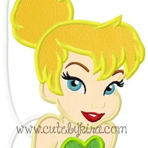 May include: Embroidered design of Tinkerbell, a fairy with blonde hair, wearing a green dress and a mischievous expression. The design includes the text "www.cutebykira.com".