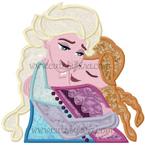 Op de afbeelding: Een geborduurd ontwerp met twee stripfiguren die elkaar omarmen. Eén personage heeft blond haar en draagt een blauwe en paarse jurk. Het andere personage heeft rood haar. De tekst "www.cutebykira.com" is zichtbaar.