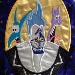 May include: Embroidered patch featuring a blue, white, and yellow character with a large grin, surrounded by two other characters, one blue and one purple, against a yellow moon background.