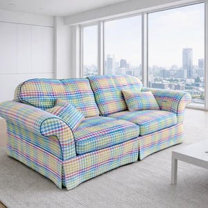 May include: A two-seater sofa upholstered in a multi-colored pastel plaid fabric featuring a grid pattern of light blue, yellow, pink, and green. The sofa includes two matching throw pillows and has dark blue piping along the edges.
