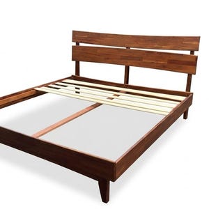 May include: A dark brown wooden bed frame featuring a tall headboard with two horizontal slats and a central vertical support. The frame includes a light-colored wooden slat base system designed to support a mattress, supported by four sturdy legs.