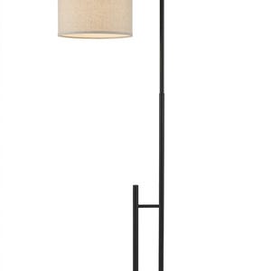 May include: A floor lamp with a matte black metal frame and a circular base. The lamp features a tall, slender vertical pole with a curved arm extending from the top to support a cylindrical, light beige fabric drum shade that emits light.