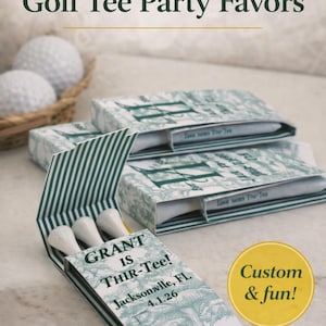 May include: Customized matchbook-style paper sleeves containing white golf tees. The green and white patterned packaging features the text GRANT IS THIR-Tee! Jacksonville, FL 4.1.26. A yellow circular badge with the text Custom & fun! is visible.