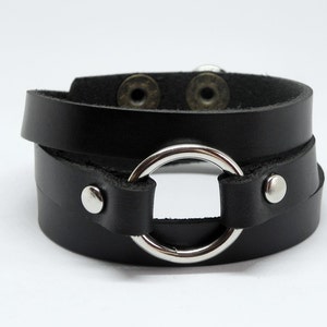 Black Leather Cuff Bracelet with Silver Tone Metal O Ring Snap Button Clasp.