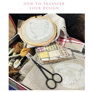 May include: A close-up of a craft project with a chicken design on fabric. The fabric is in an embroidery hoop and there are embroidery floss, scissors, and other craft supplies in the background. The text "HOW TO TRANSFER YOUR DESIGN" is at the top of the image.