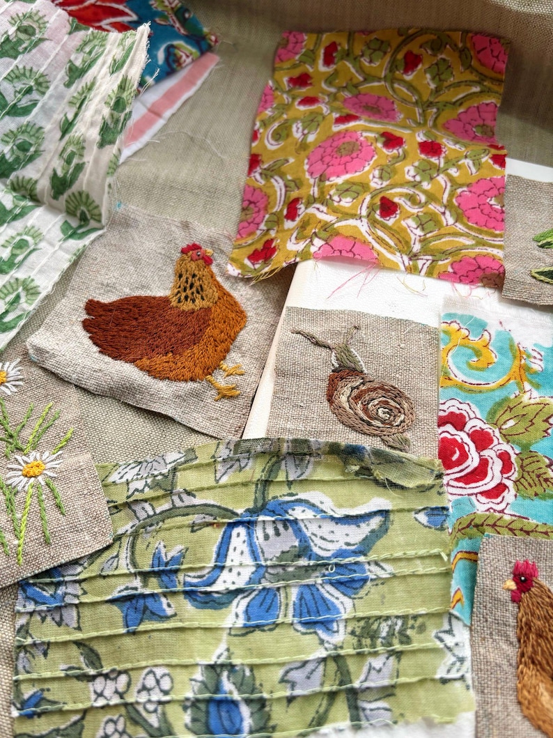 May include: A collection of fabric scraps featuring various patterns and embroidery. Pieces include a yellow floral print, a green and blue floral print, a brown embroidered chicken, a brown snail, and white daisies on linen.