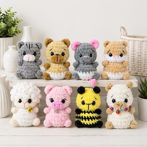May include: Eight handmade crochet stuffed animals are displayed, including a grey cat, a beige bear, a grey mouse, a beige tiger, a white lamb, a pink pig, a yellow bee, and a white lamb. Each has unique features and colours.