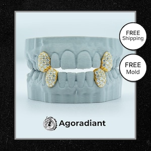 May include: A set of three gold-plated teeth with diamond accents, displayed on a white dental mold. The teeth are designed to be used as a grill, a type of removable dental jewelry. The image includes the text "FREE Shipping" and "FREE Mold".