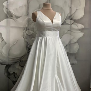 Sleeveless Satin Ball Gown Wedding Dress: Deep Neckline, Lace Corset