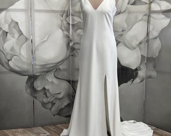 Minimalist wedding dress with V-neckline and low back, modern bridal slip gown with train and front slit