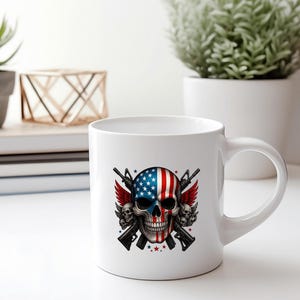 May include: White ceramic mug featuring a skull design with the American flag on one side and a detailed illustration of guns, wings, and stars. The mug has a curved handle and is suitable for hot or cold beverages.